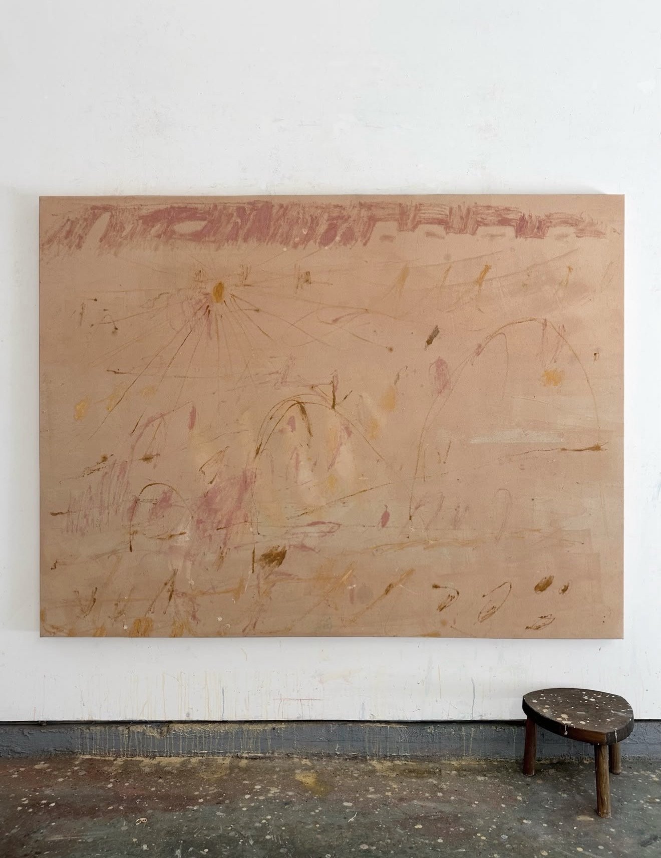 A roll of canvas on the studio floor